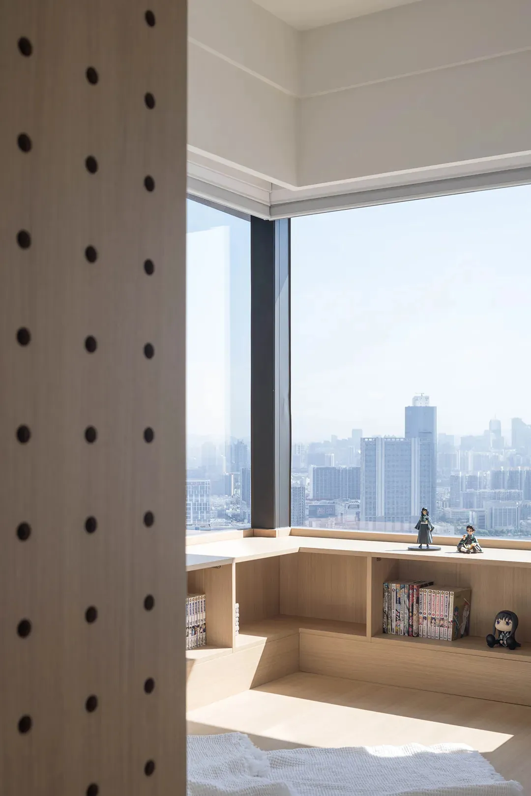 Modern room featuring wood shelves and a city view.