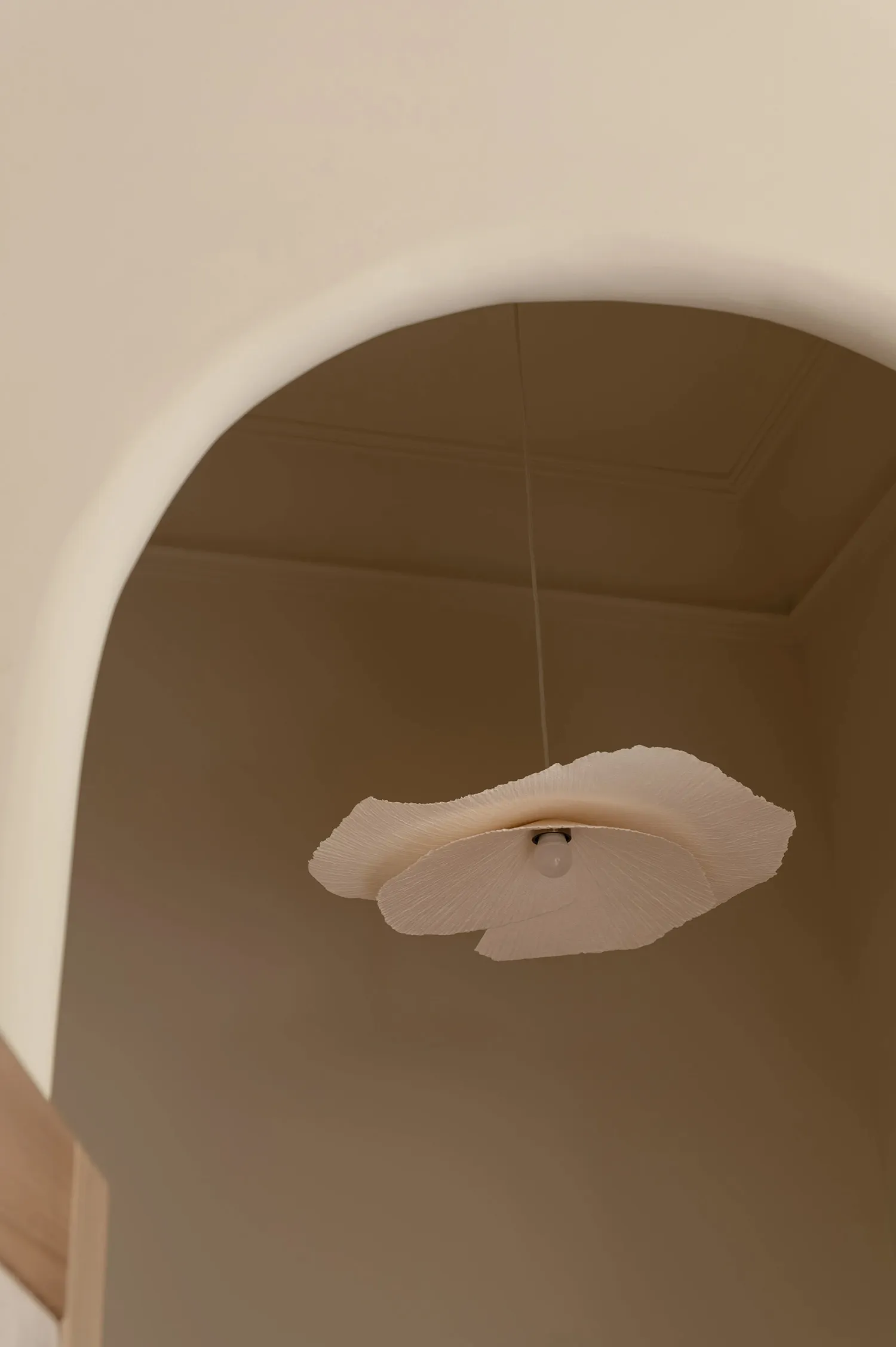 A modern ceiling lamp with textured paper shades hanging from a ceiling