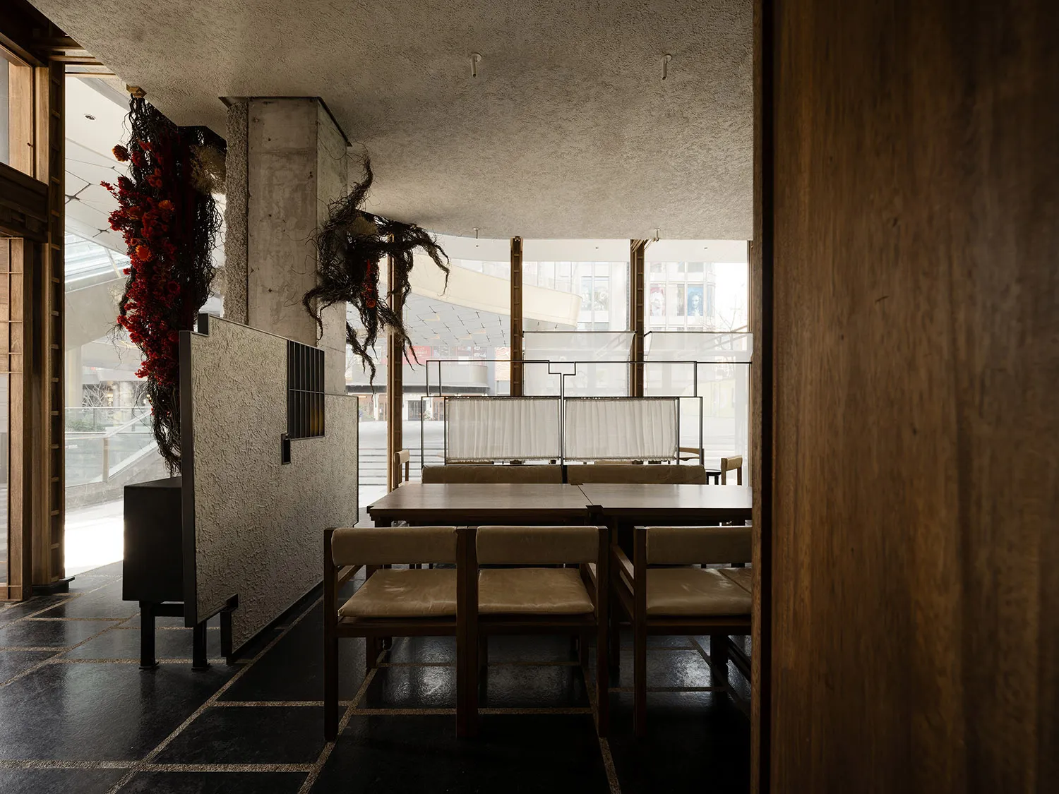 Modern dining room with wooden tables and chairs.