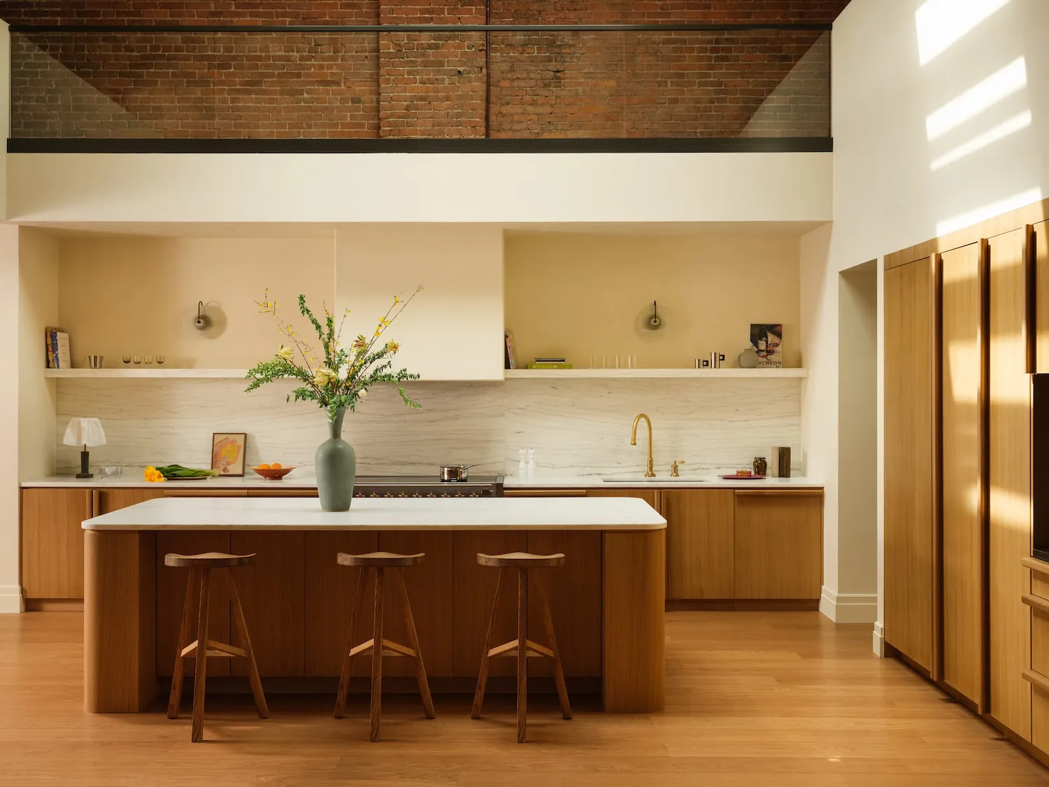 A modern kitchen featuring wooden cabinets and marble countertops