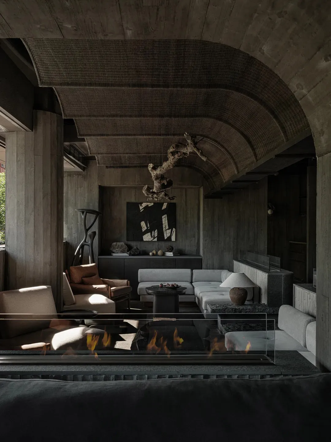 A living room with industrial design features, concrete materials, and minimalist furniture.