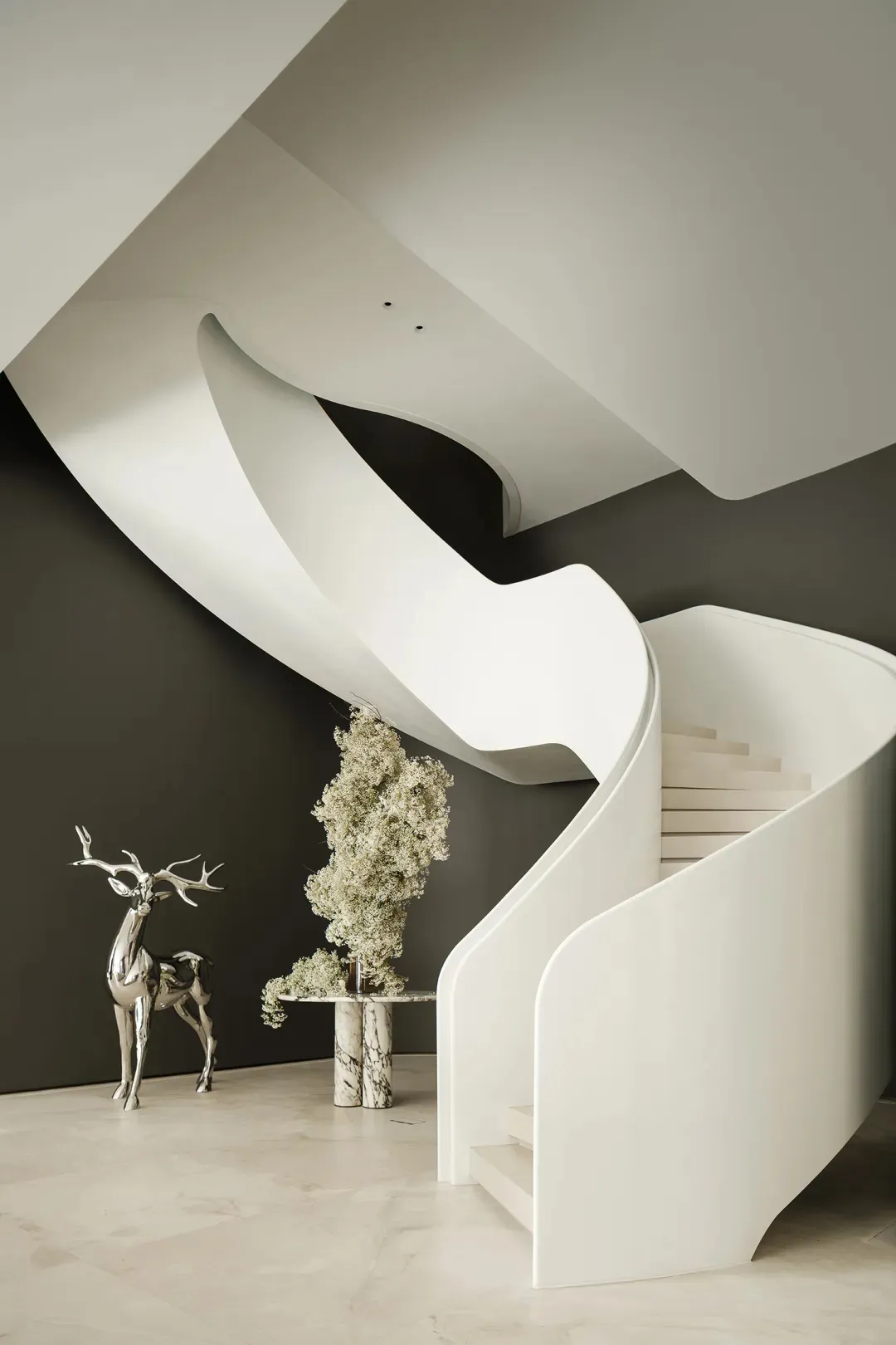 A sleek, modern staircase made of white marble.