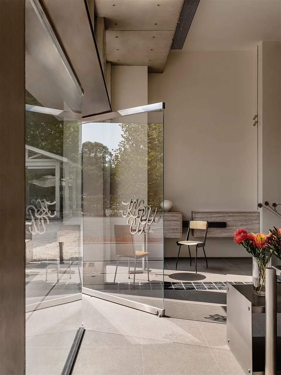 Modern lobby featuring glass walls and concrete elements