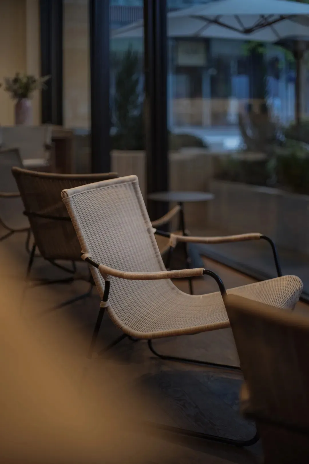 A cozy interior space featuring woven fabric chairs and a serene atmosphere.