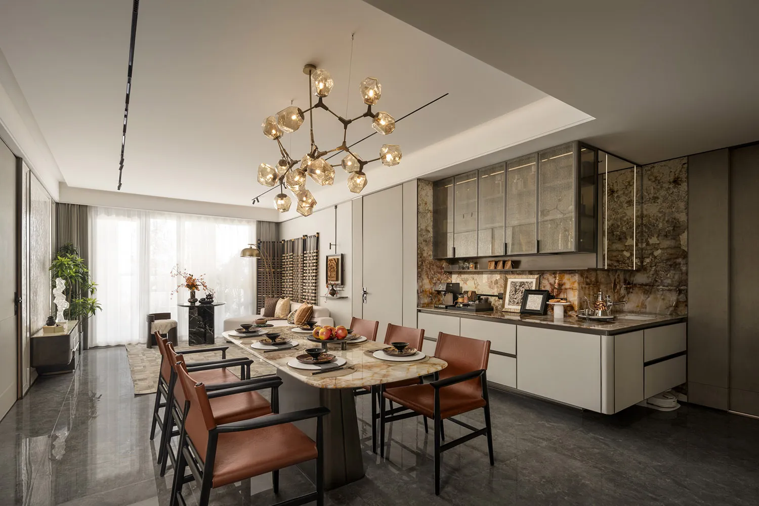 A modern dining room with a marble and leather table surrounded by brown chairs, under a chandelier with multiple light bulbs