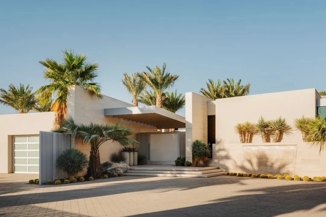 Modern home entrance featuring concrete and glass materials.