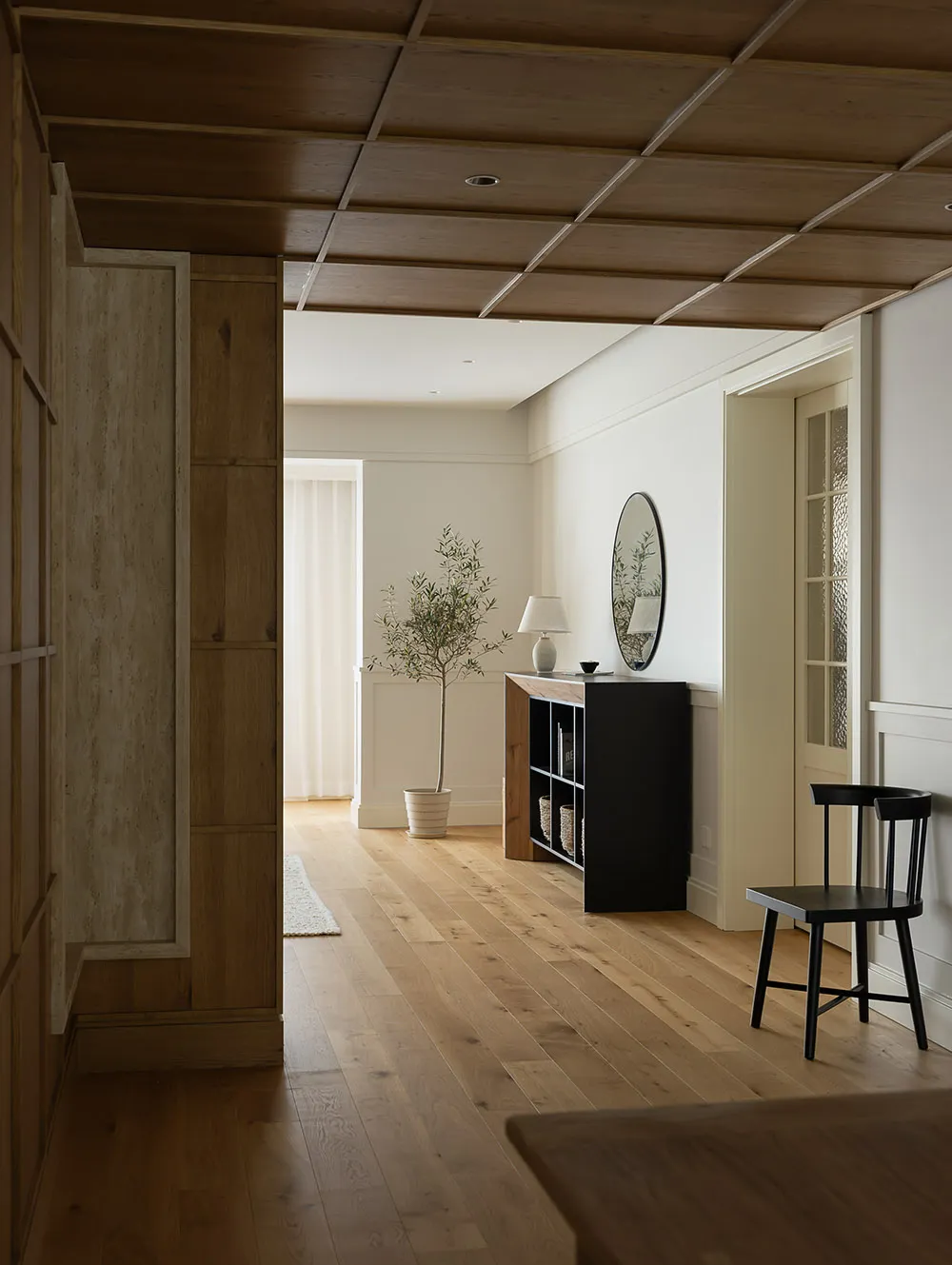 Minimalist living room with wood flooring and black chair