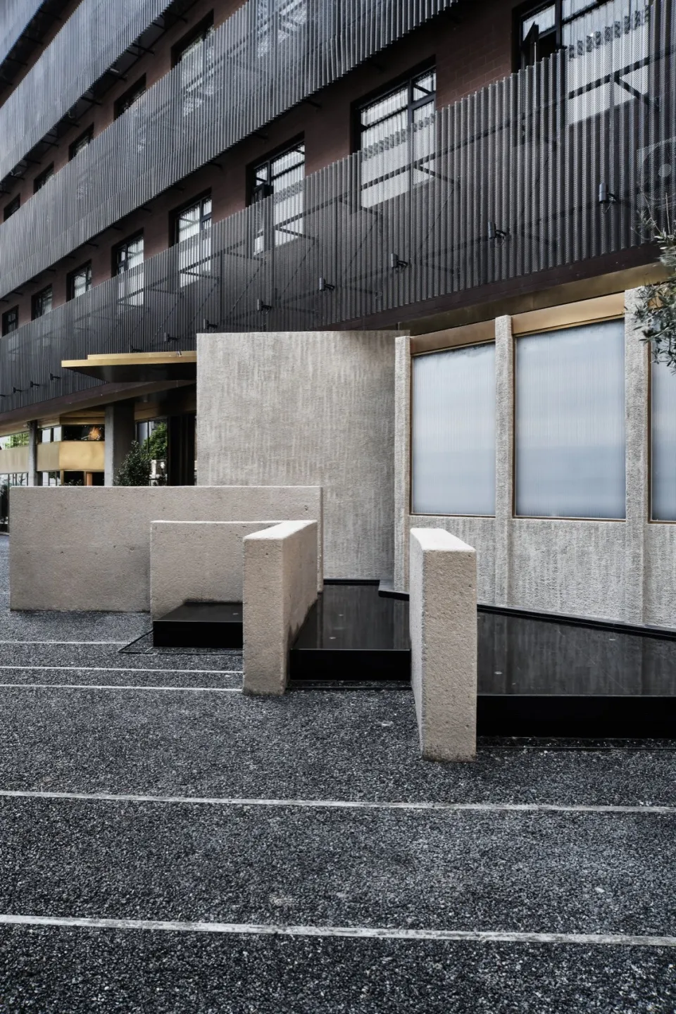 Concrete urban retail storefront with large windows and sleek modern design.