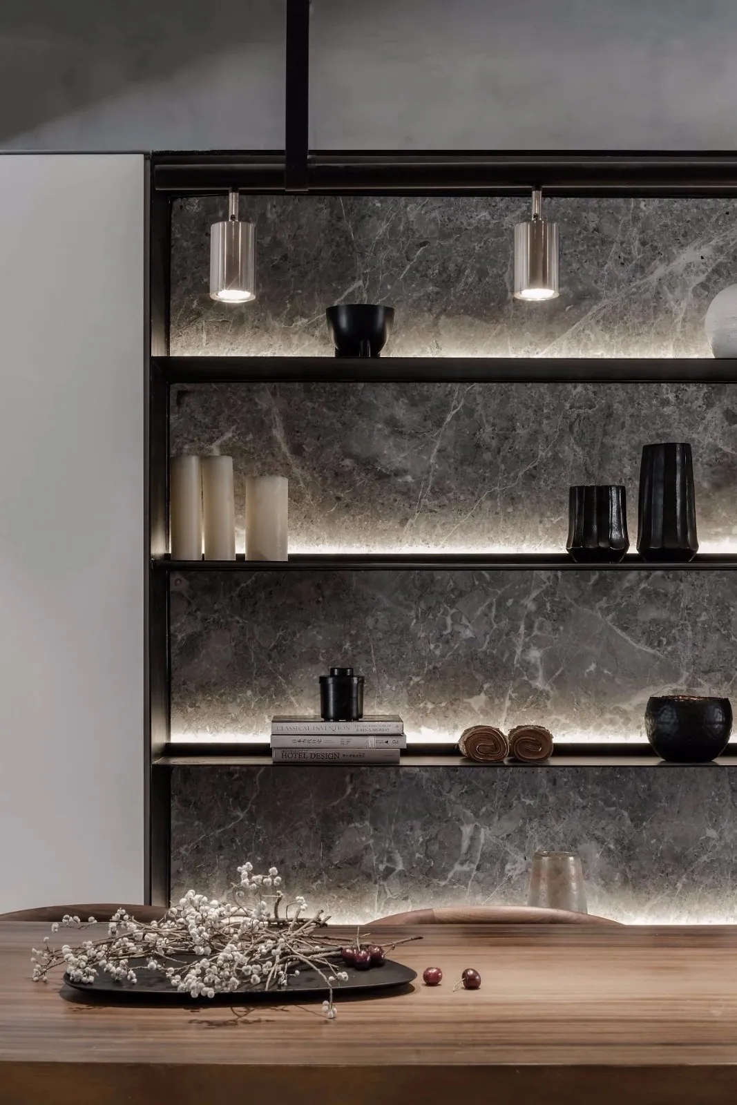 A modern kitchen with marble countertops and shelves.