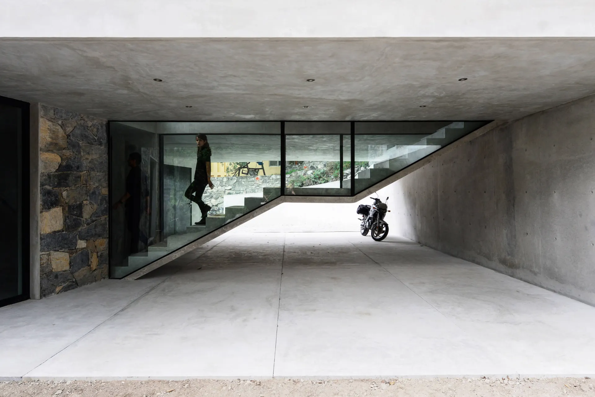 Concrete, minimalist interior space with a modern aesthetic.