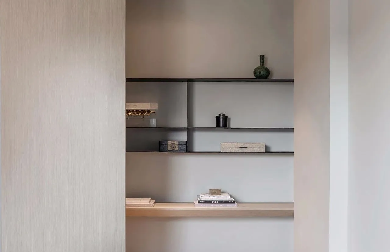 Minimalist modern interior closet with metal shelves and black accents.