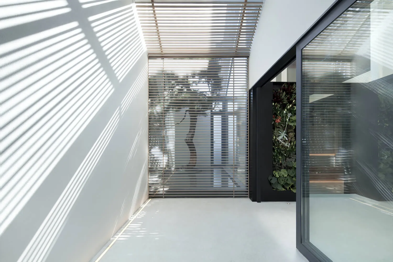 Modern industrial interior design featuring metal, glass, and concrete materials.