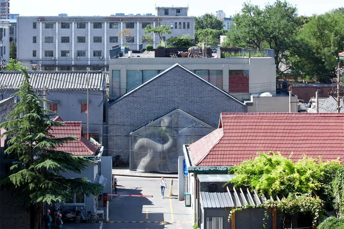 An overhead shot of an urban development with modern brick buildings and greenery.