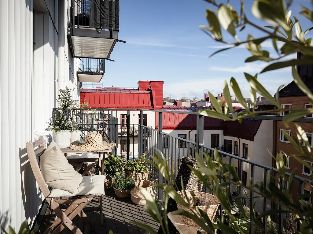 A minimalist balcony featuring planters with greenery.