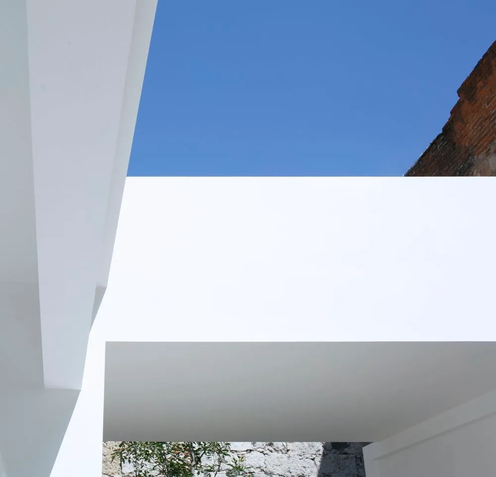 A minimalist architectural space featuring clean lines and glass elements.