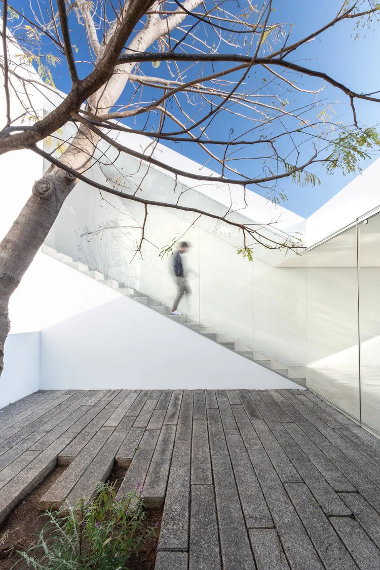 A minimalist interior design featuring glass and concrete materials.