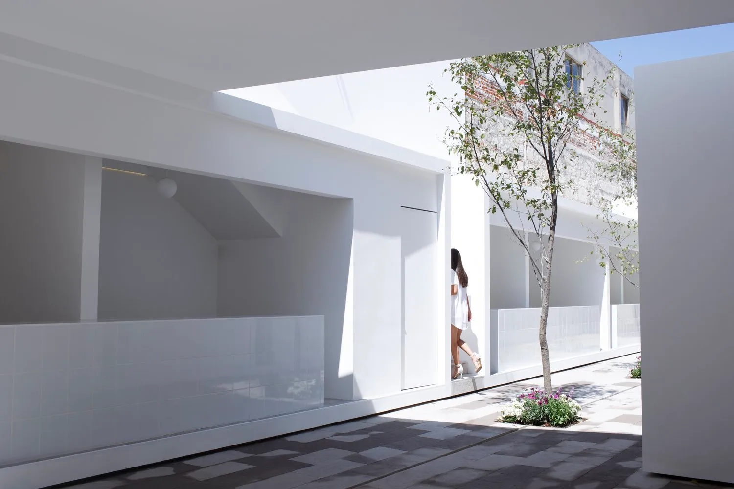 A minimalist white interior design with natural light, clean lines, and a serene atmosphere.