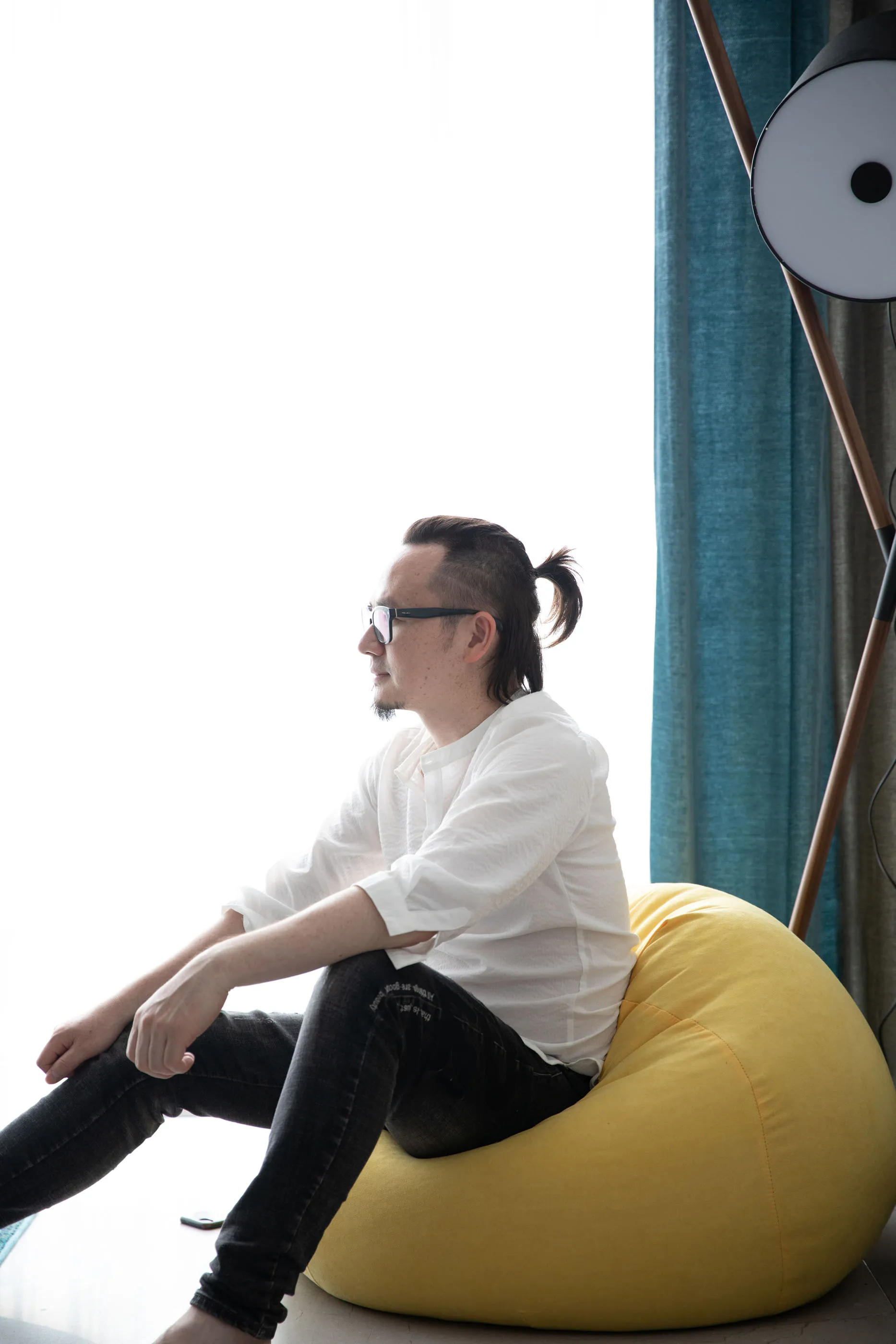 Person sitting on a yellow beanbag chair