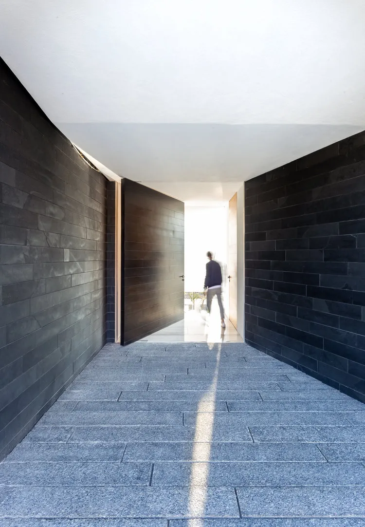 A modern pathway with concrete flooring and walls.