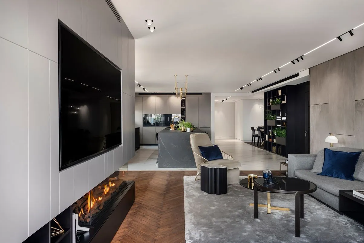 Modern living room with concrete tiles, minimalist furniture, and a fireplace.