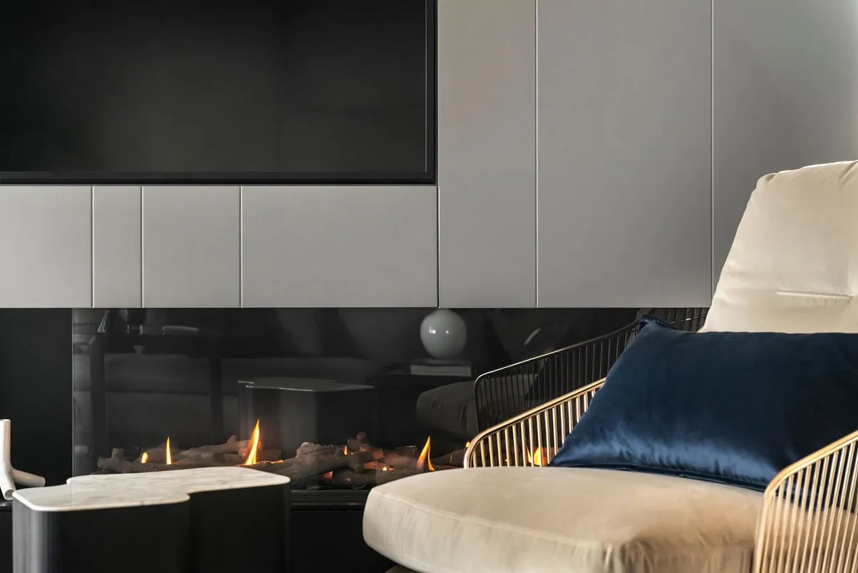 Modern living room featuring sleek, metal furnishings and glass surfaces.
