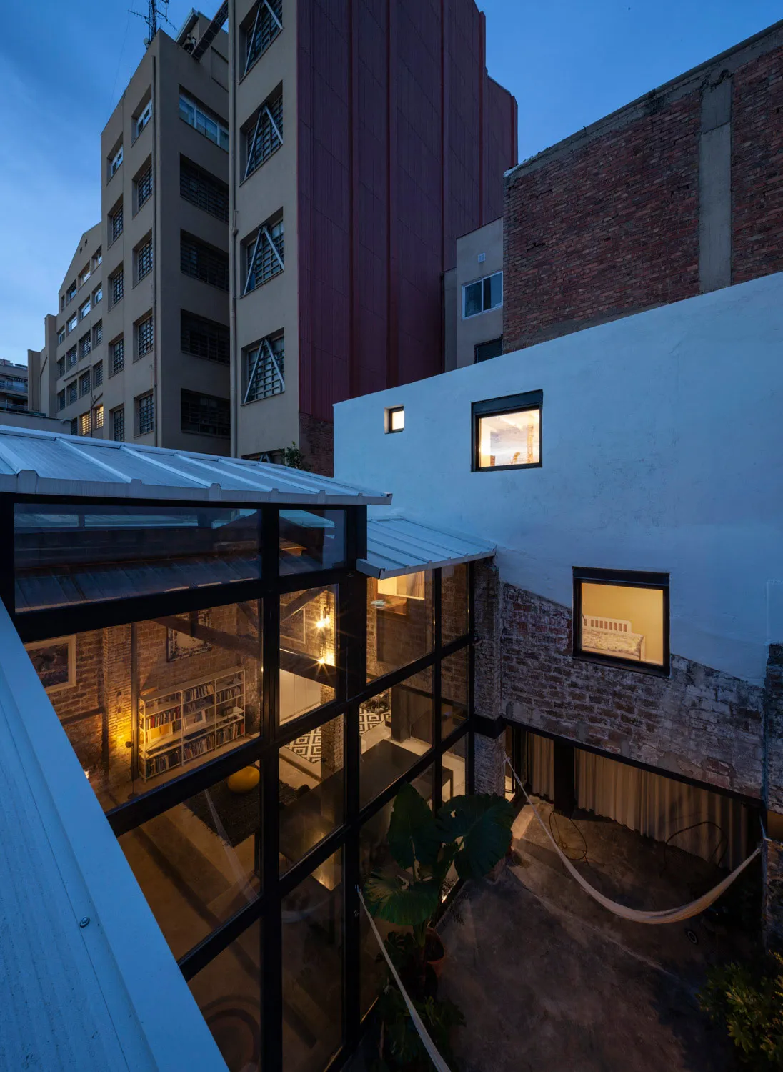 A renovated residential space with brick, concrete, and glass materials.