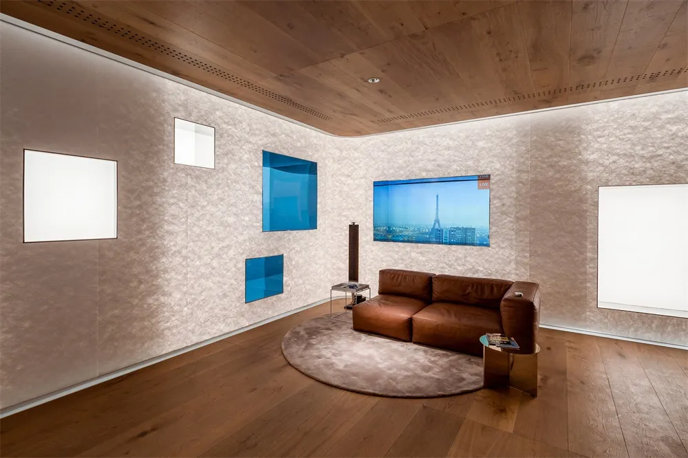 A modern living room with wooden walls and a brown leather sofa.