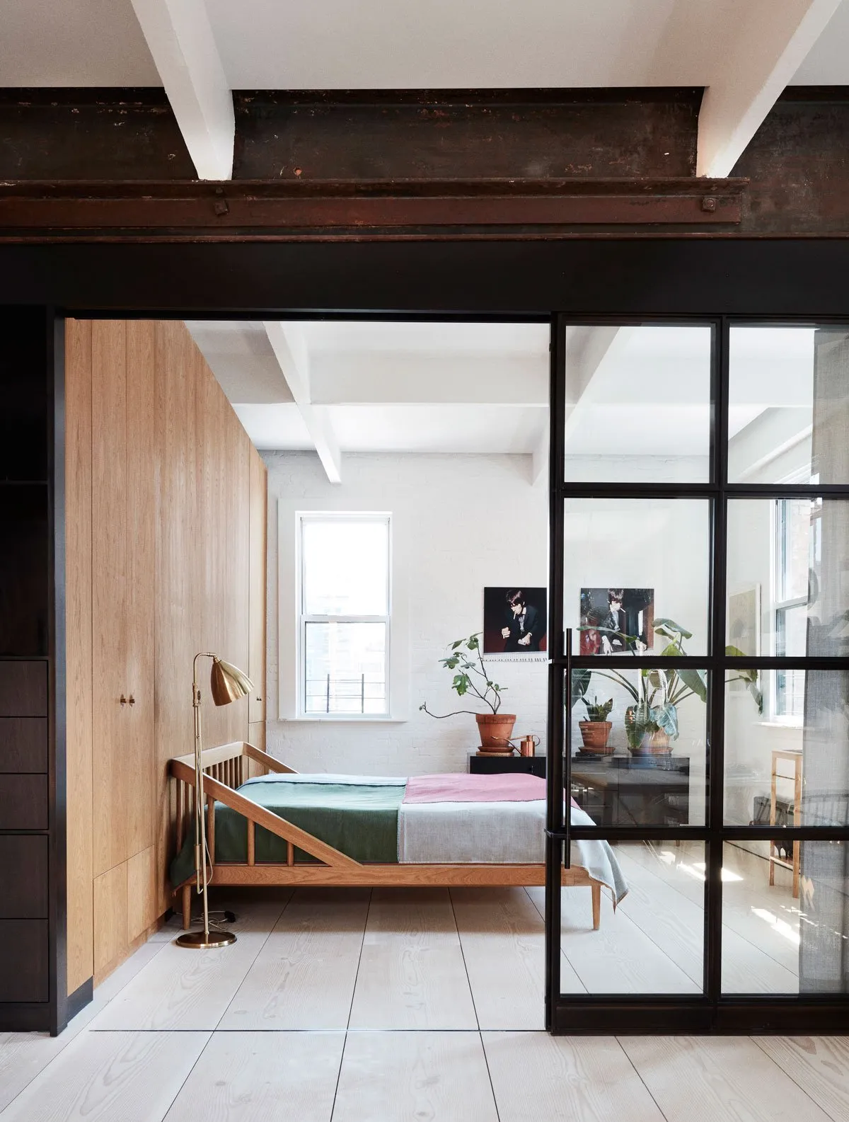 A minimalist bedroom featuring wood and glass elements.