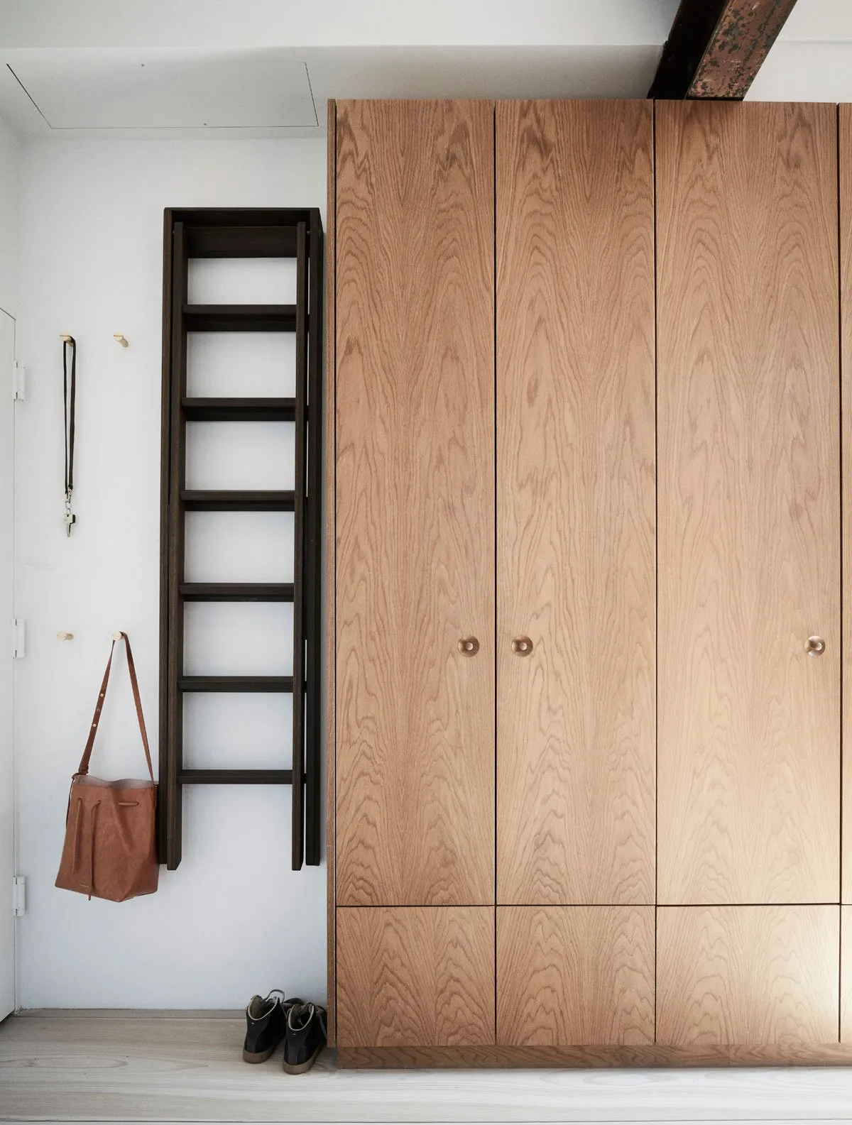 Modern, wooden wardrobe with sleek, stylish design and metal handles.