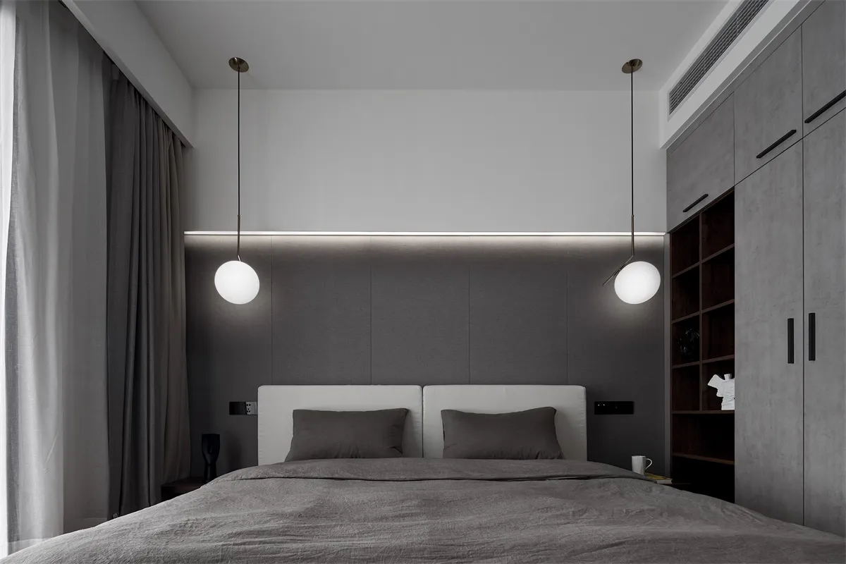 Modern bedroom with minimalist design featuring textured concrete walls.