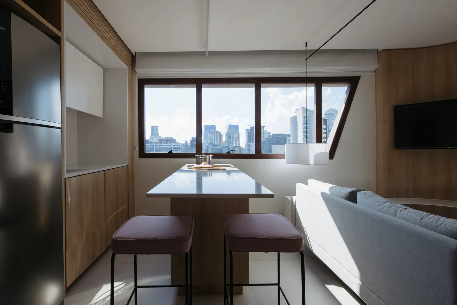 Modern minimalist living room featuring a large window overlooking a cityscape.