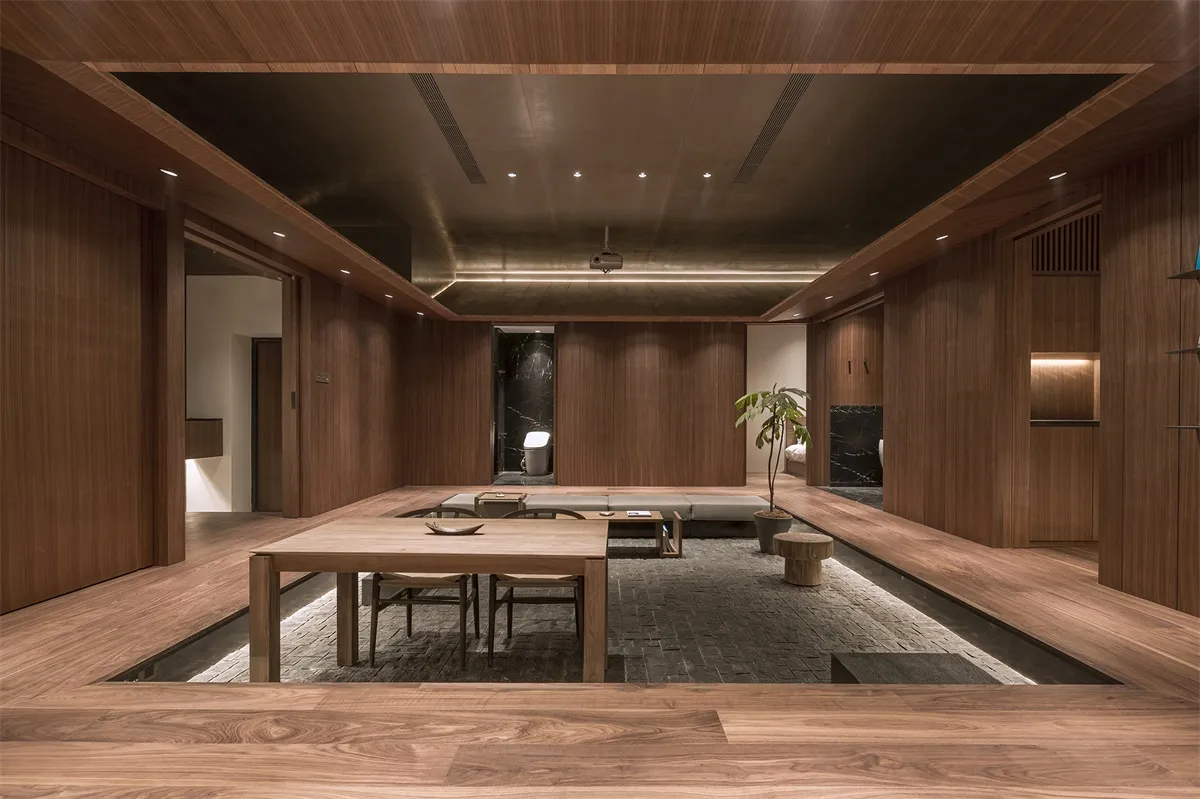 A minimalist restaurant interior with wooden elements and seating area