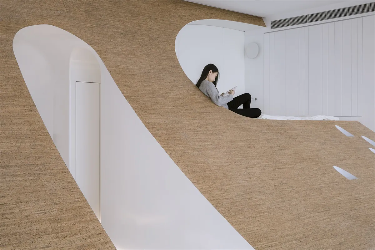 A modern minimalist living space featuring wooden elements and clean lines.