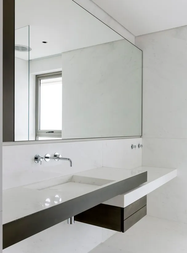 Modern bathroom with marble countertop and white marble walls