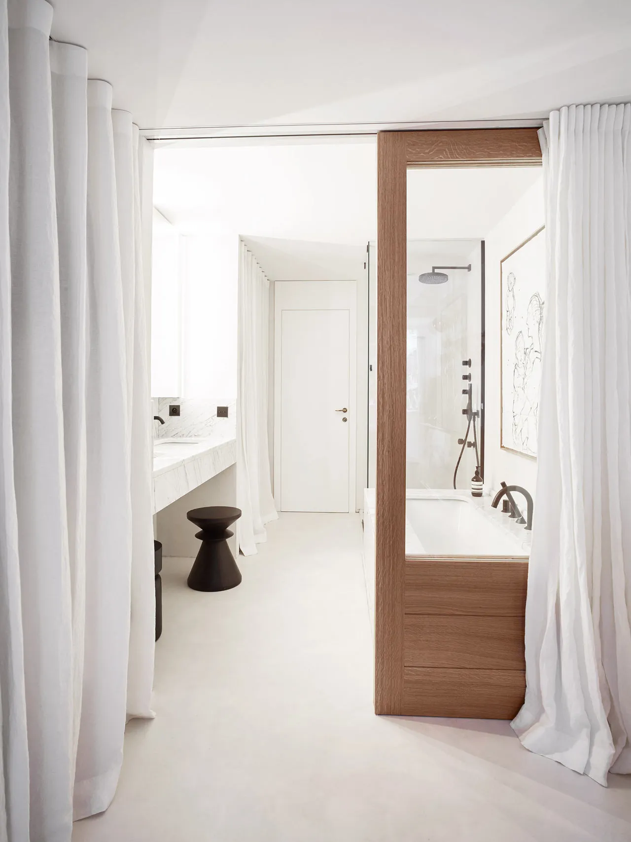 A modern bathroom featuring a white marble top and a wooden bathtub enclosure, with a white curtain and floor.