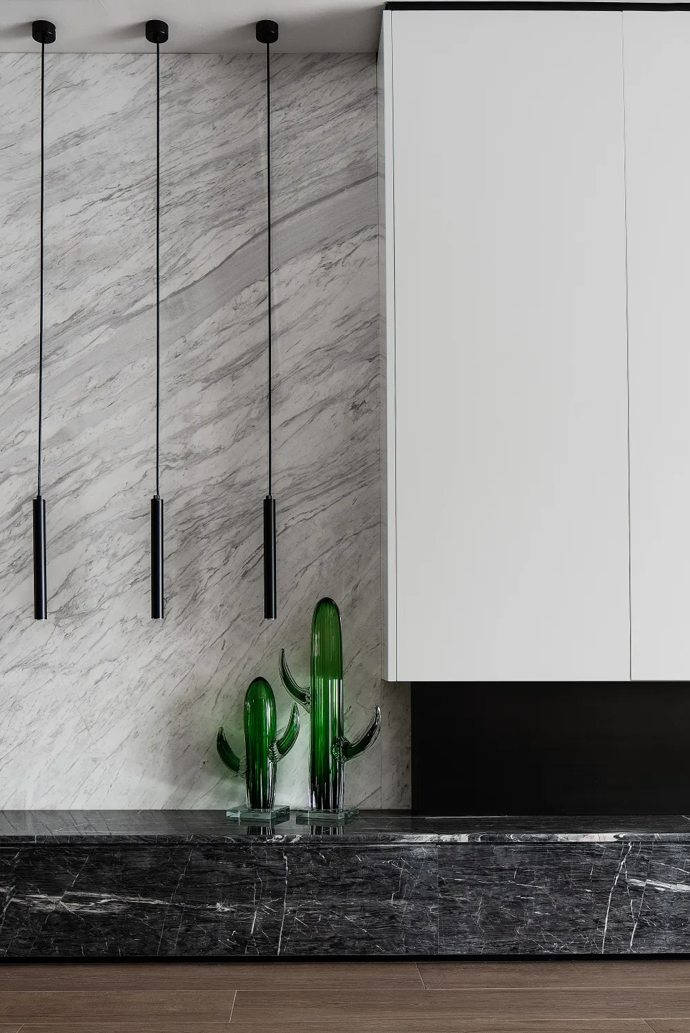 A modern interior design featuring marble surfaces and minimalist decor.