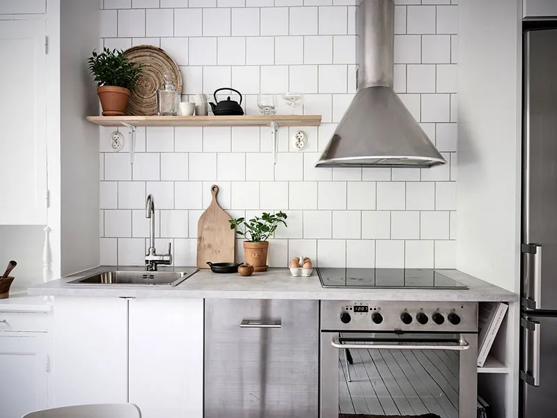 Modern minimalist kitchen featuring white subway tile backsplash.