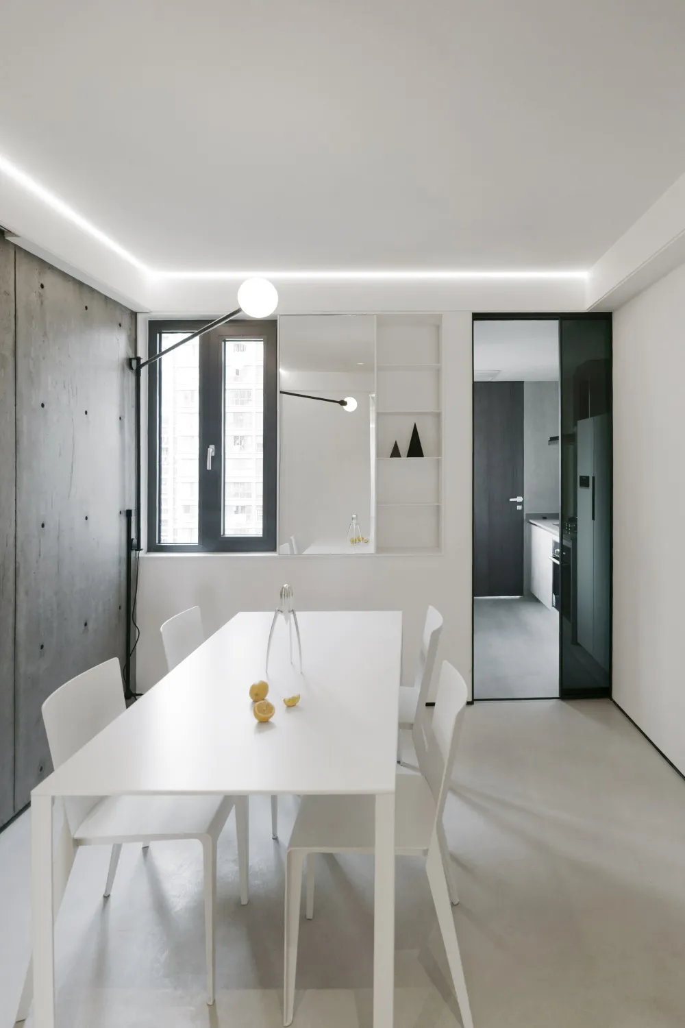Modern minimalist kitchen with white cabinets and white countertops.