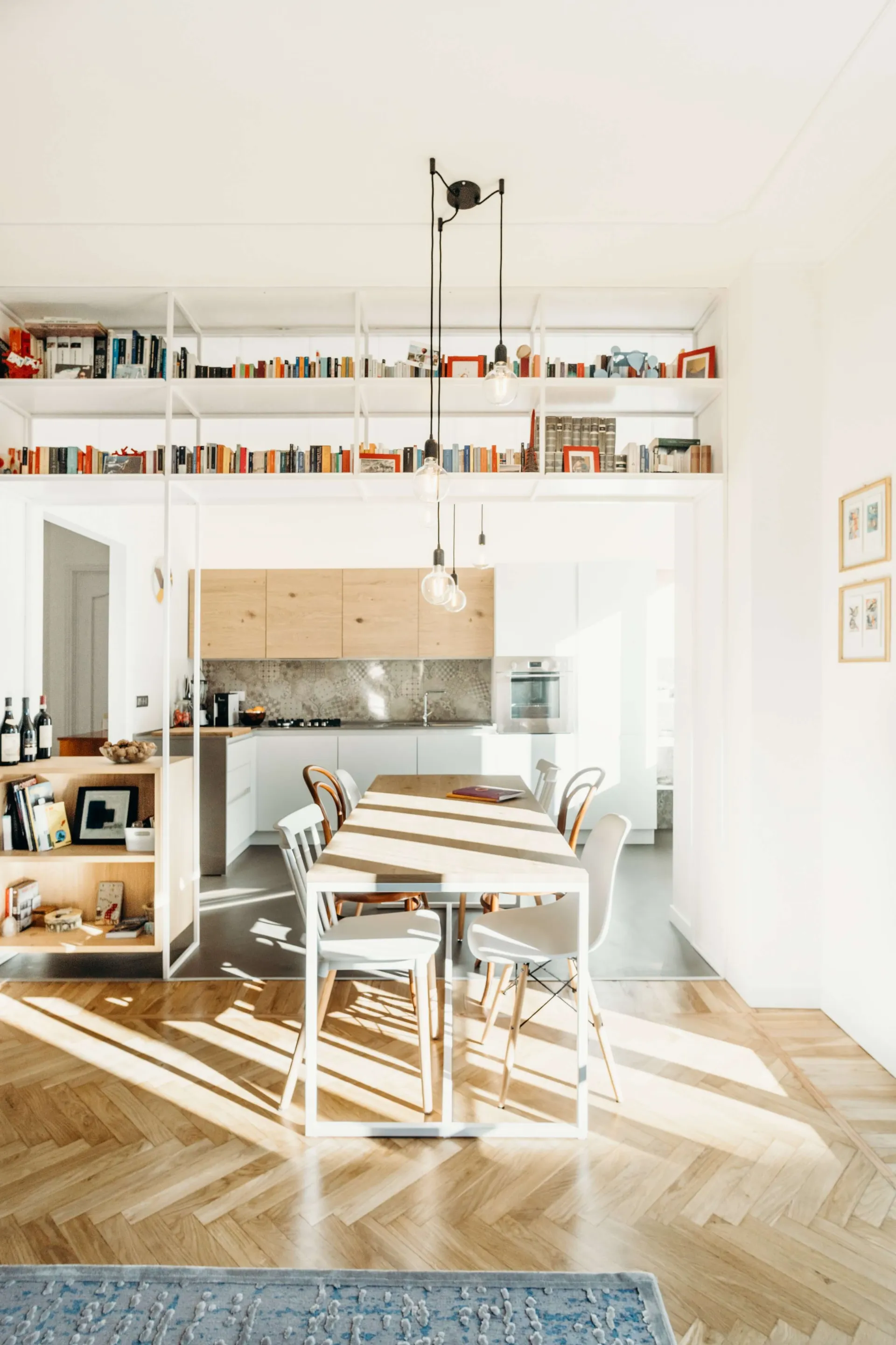 Modern open-plan living, dining, and kitchen area with wooden and metal accents