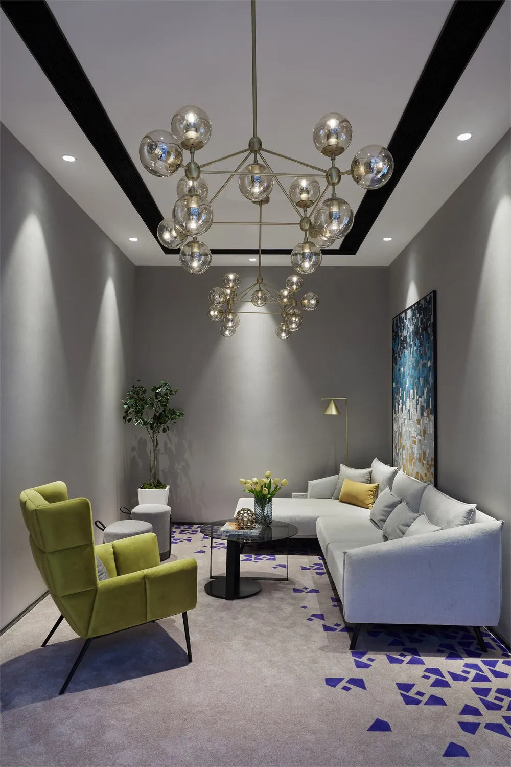 A modern living room featuring velvet furniture, concrete floor, and patterned rug