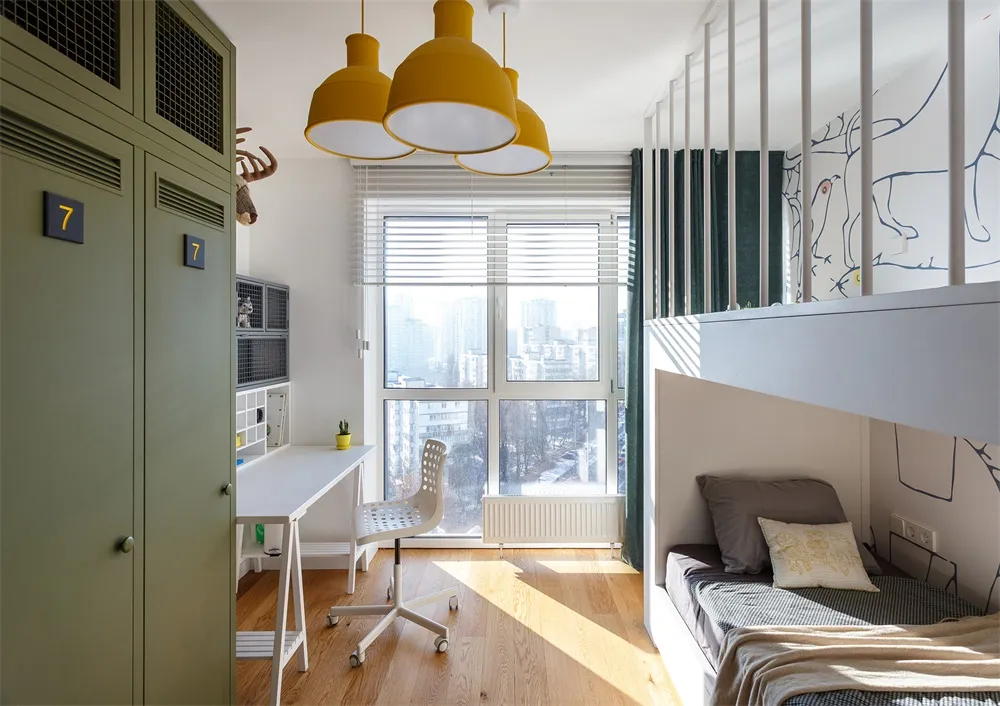 Modern child room with wooden floors, metal bunk bed, and fabric bedding.