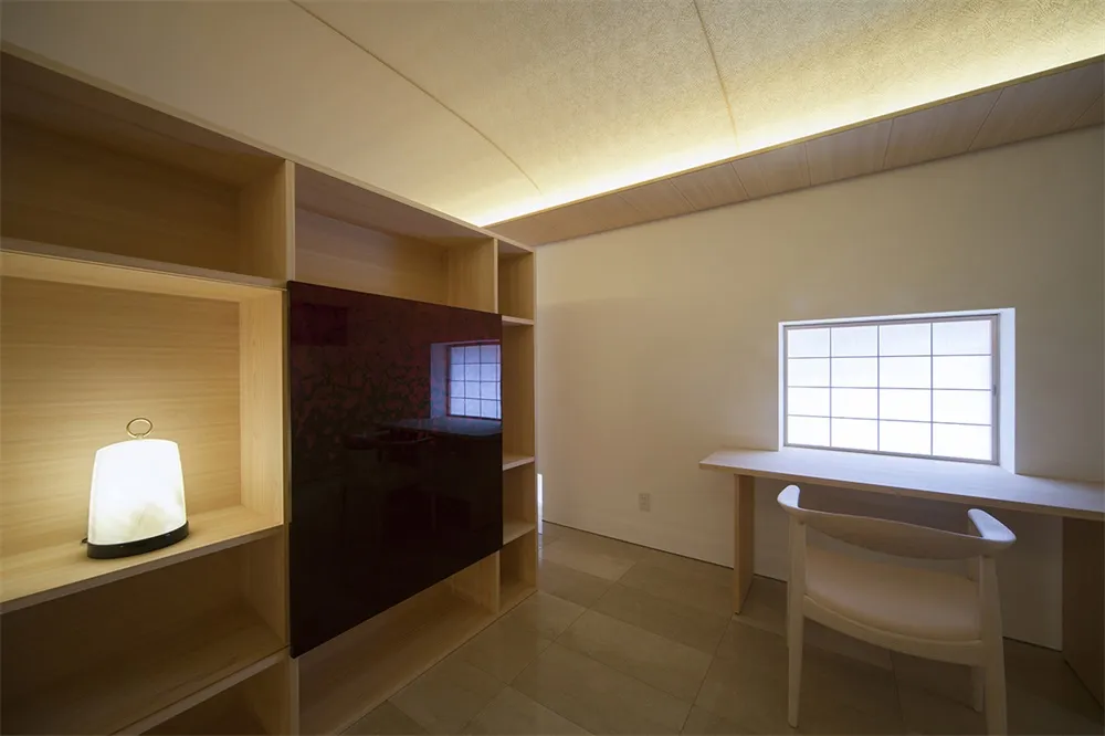 A minimalist study area with wooden shelves and a desk.
