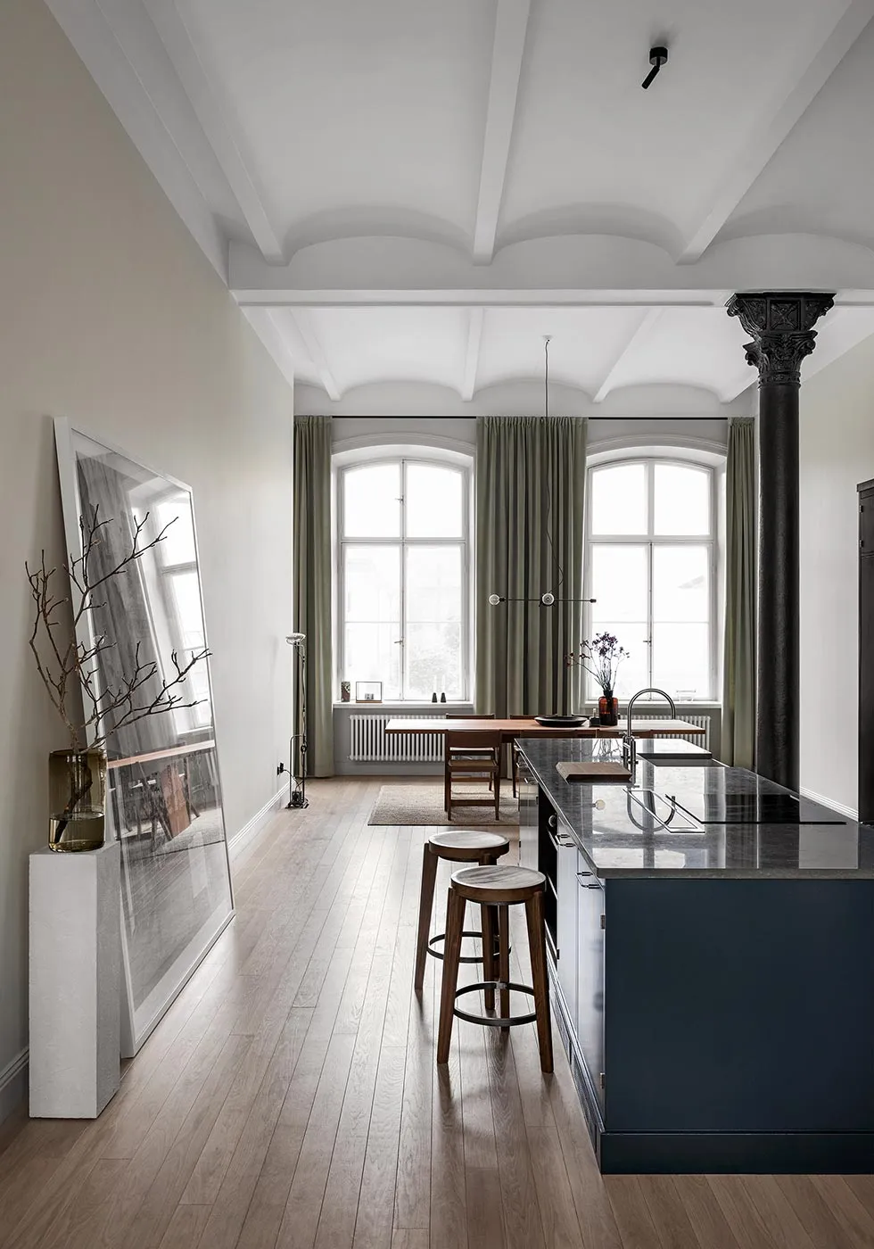 A minimalist apartment kitchen featuring wooden elements