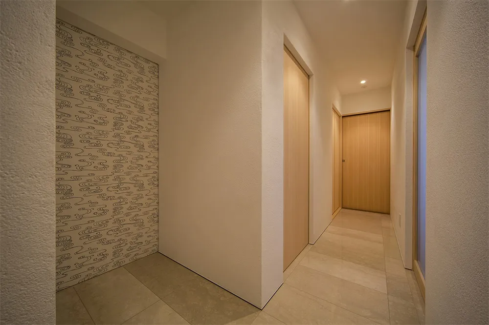 A minimalist house hallway with wooden walls and doors.
