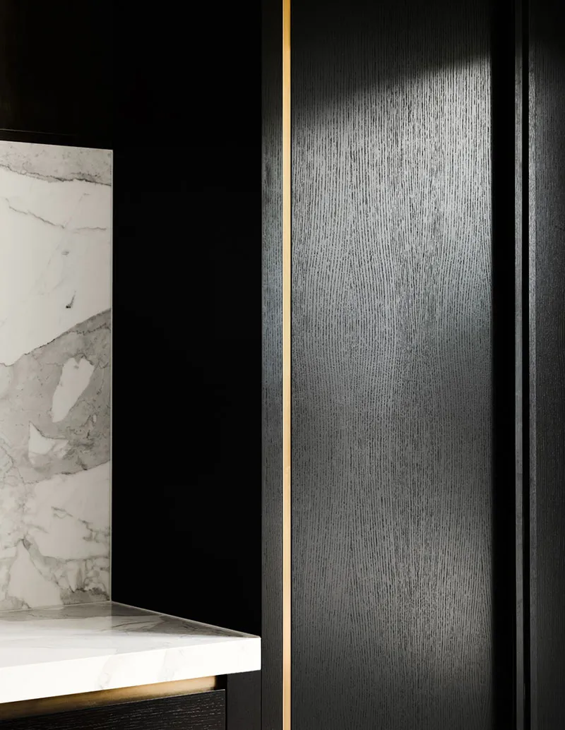 Close-up of a modern minimalist bathroom with black marble countertops and white gold-edged marble surfaces.