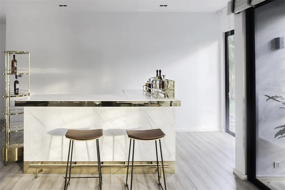Minimalist design with white marble top and bar stools.