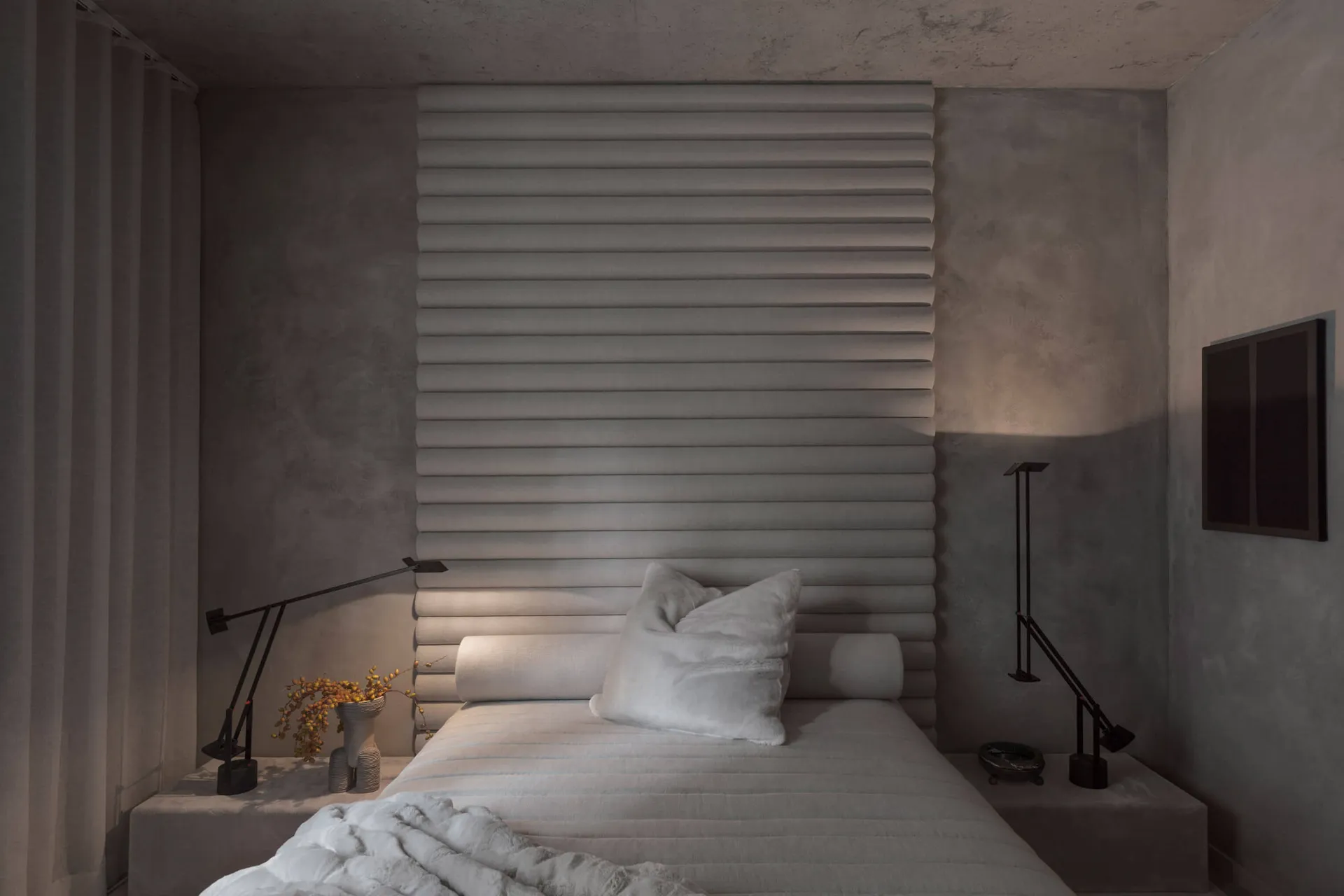 Modern minimalist bedroom featuring a fabric headboard and soft lighting.