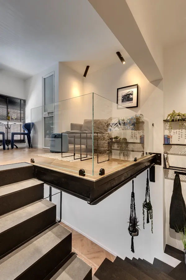 Industrial-style living area featuring concrete flooring and minimalist furniture.