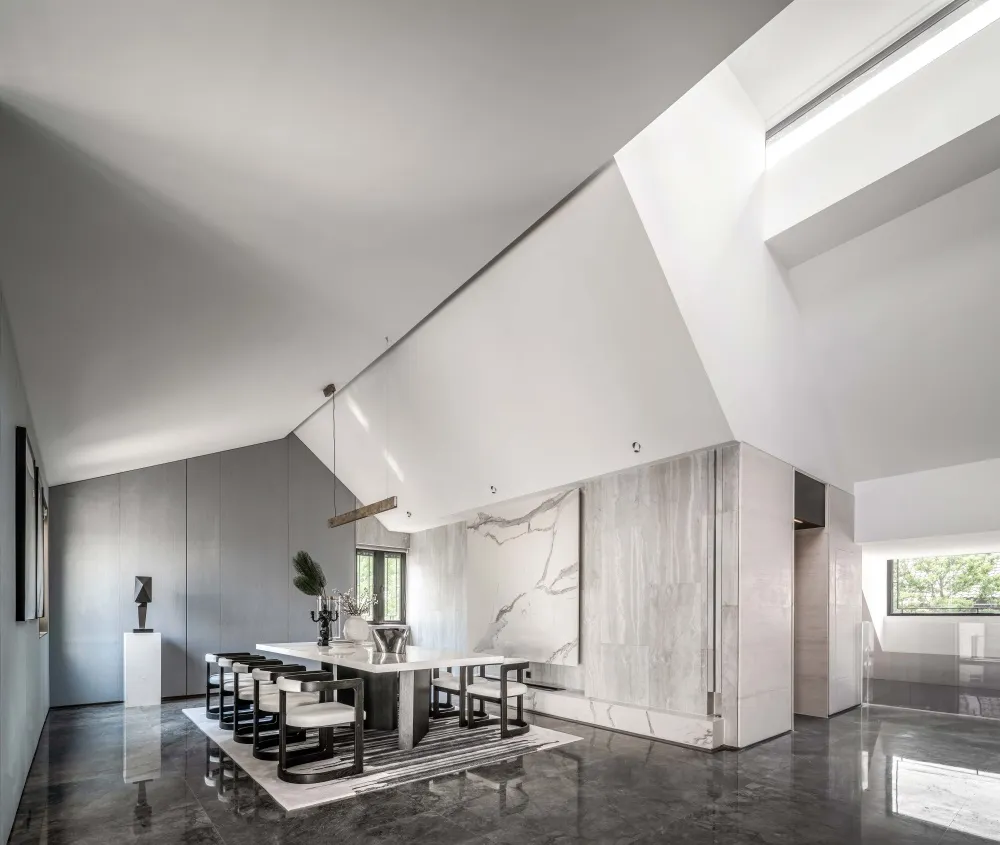 A modern dining room featuring marble elements and minimalist design.