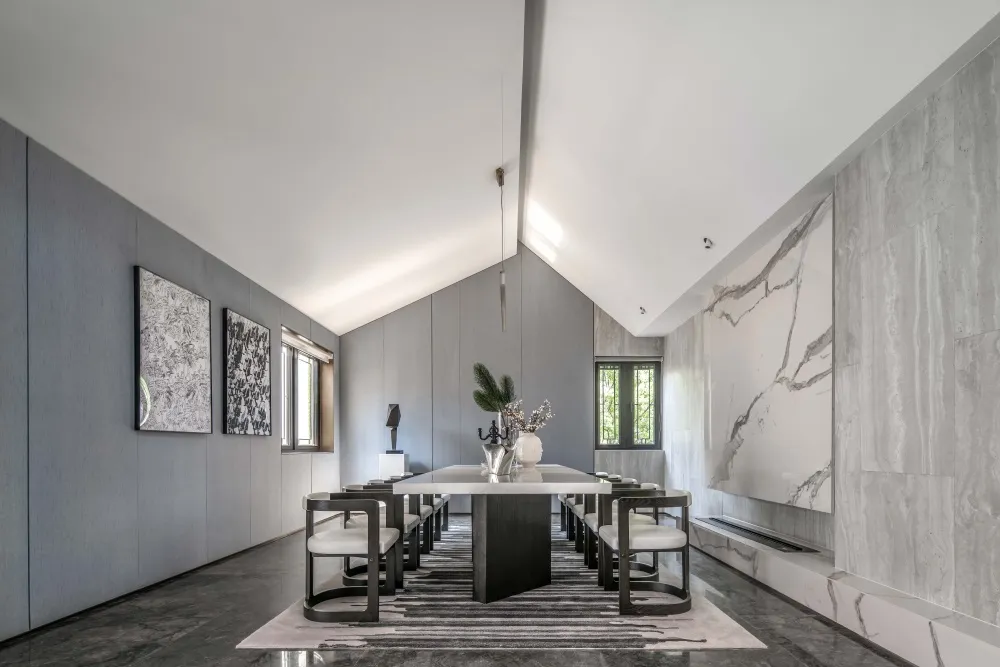 A modern dining room with marble accents and a minimalist design.